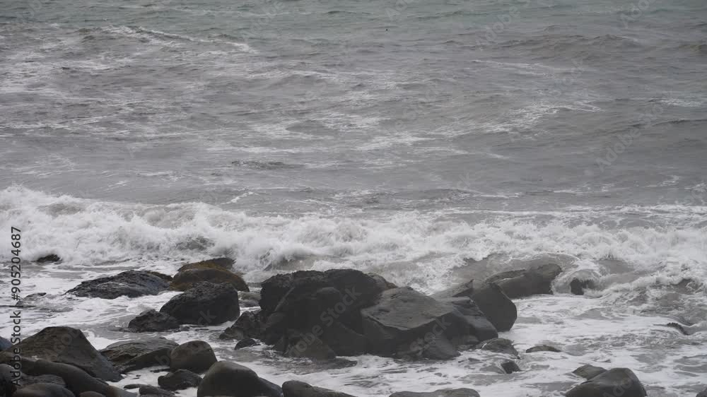 Slow-motion shots of ocean waves crashing on the shore in Iceland, highlighting the serene and breathtaking beauty of the natural landscape. Slow-motion shots of ocean waves crashing on the shore in Iceland, highlighting the serene and breathtaking beauty of the natural landscape.