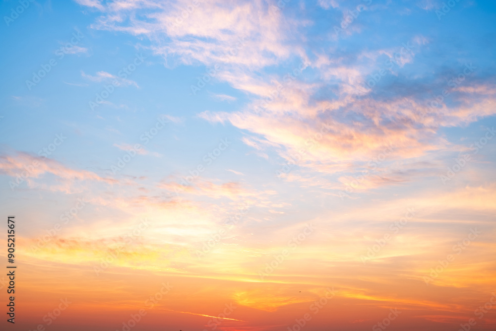 Obraz premium Beautiful , luxury soft gradient orange gold clouds and sunlight on the blue sky perfect for the background, take in everning,Twilight, Large size, high definition landscape photo