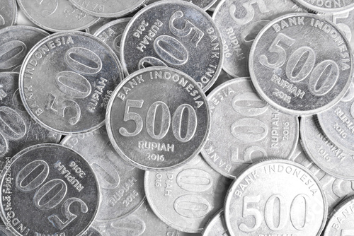 Stack of 500 rupiah coins on white background. National currency. Indonesian rupiah coin. Top view photo