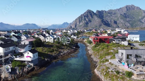 Henningsvær typical Norwegian village seen from above from a drone view with sailboat 