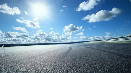 A race track stretches out under a clear blue sky, with a bright sun shining down on the asphalt. The image symbolizes speed, freedom, and the pursuit of victory.