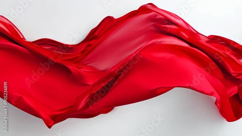 Elegant red silk fabric gracefully flowing in smooth waves on white