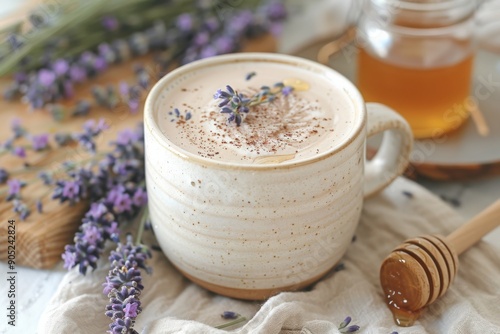 A close-up of a lavender latte with honey, garnished with fresh lavender sprigs