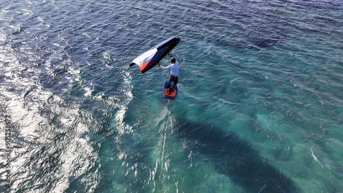Photography Aerial drone high speed tracking shot of athlete racing in wind surfing Hydro fo