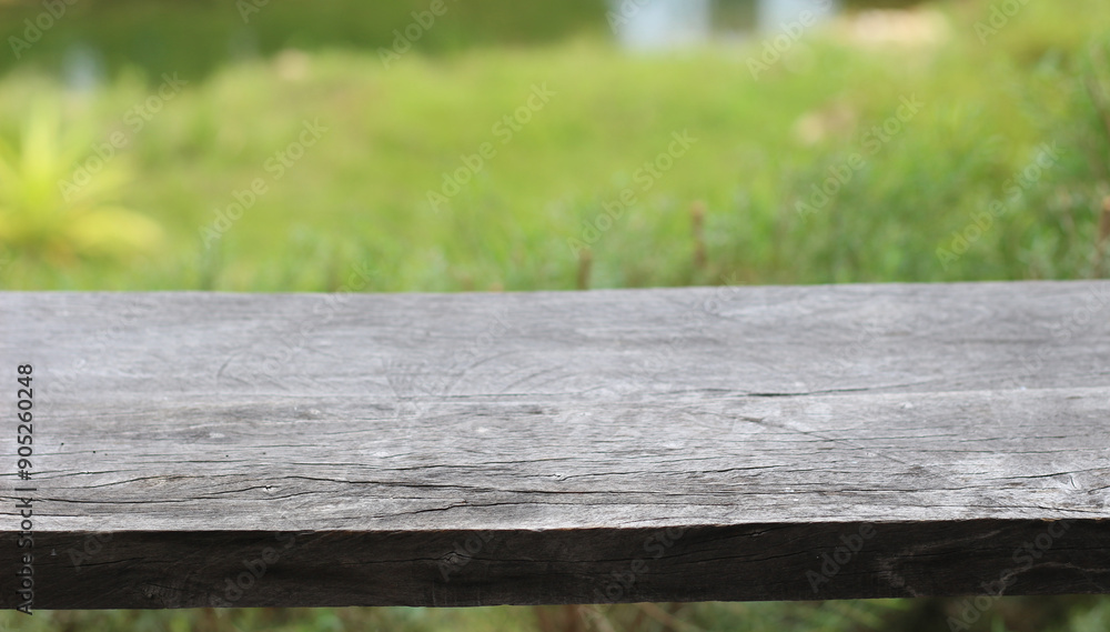 Fototapeta premium Empty wooden on blur green nature background. Ready for product display.