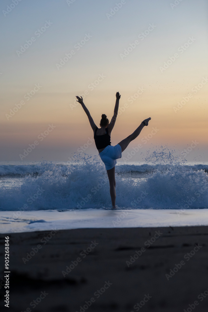 girl or woman dancing on a beach with waves after sunset in the golden hour girl or woman dancing on a beach with waves after sunset in the golden hour