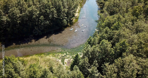 karst blue lake in the forest and SUP boards