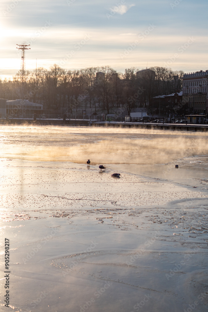 helsinki seaside promenade on a cold icy winter day in helsinki finland with sunset in the background helsinki seaside promenade on a cold icy winter day in helsinki finland with sunset in the background