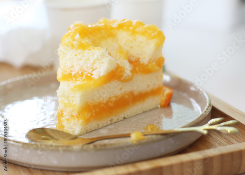 orange cake on plate with spoon at cafe