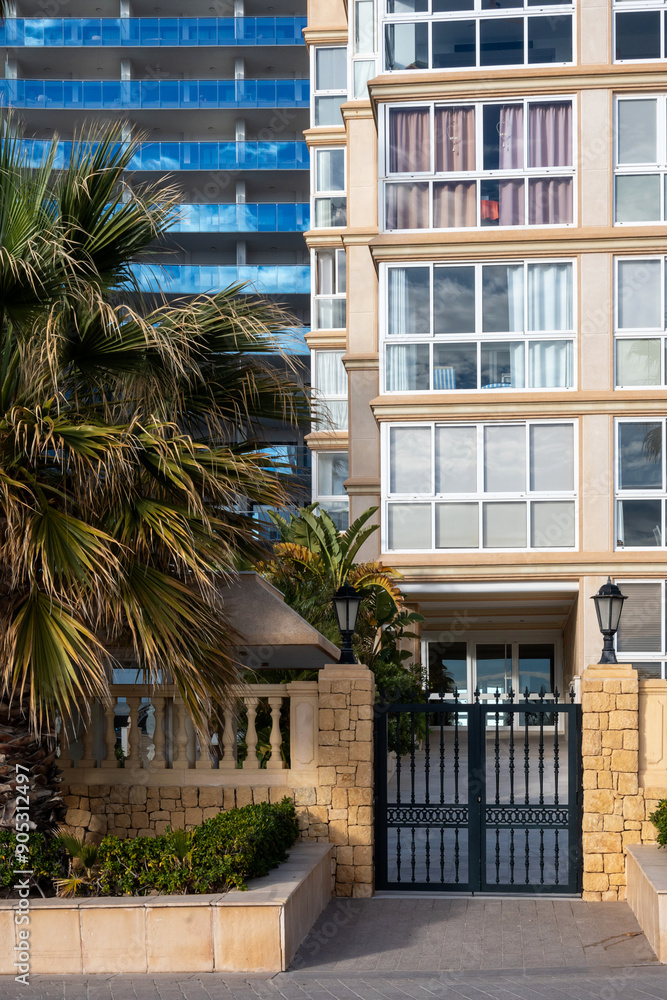 Gate entrance to a modern multi-store apartment building, concept luxury living, property sale or rent at holiday destination Gate entrance to a modern multi-store apartment building, concept luxury living, property sale or rent at holiday destination