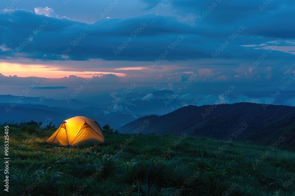 Glowing Tent on Grassy Hilltop Overlooking Misty Mountains at Dusk During Isolated Camping Adventure Glowing Tent on Grassy Hilltop Overlooking Misty Mountains at Dusk During Isolated Camping Adventure