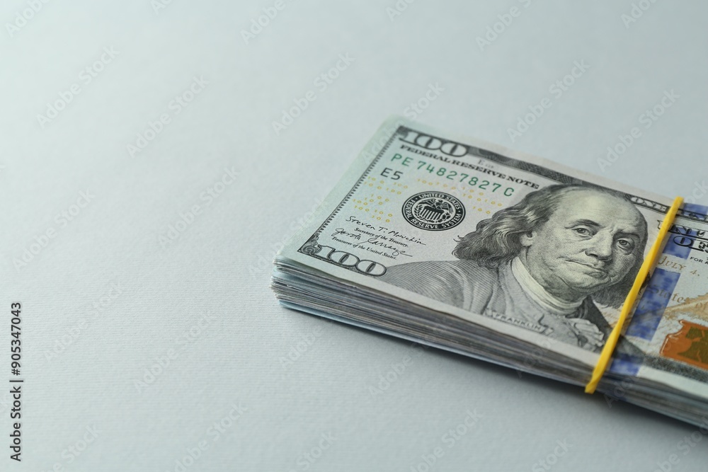 Dollar banknotes on grey background, closeup. Space for text Dollar banknotes on grey background, closeup. Space for text
