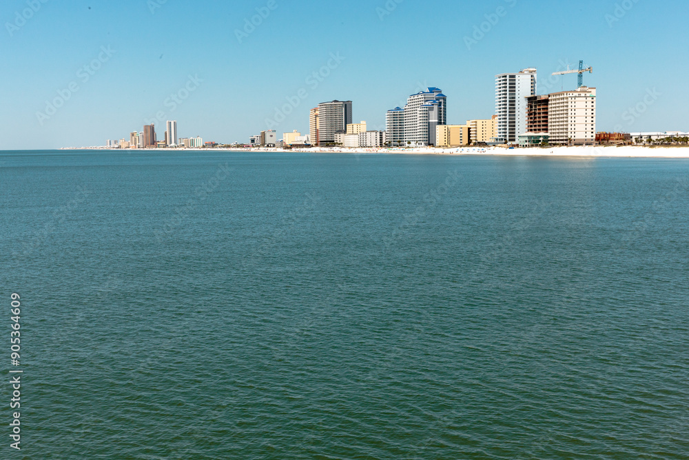 Looking back at the coastal shoreline development of Gulf Shores, Alabama, as seen from the fishing pier within Gulf State Park, Gulf Shores, Alabama Looking back at the coastal shoreline development of Gulf Shores, Alabama, as seen from the fishing pier within Gulf State Park, Gulf Shores, Alabama