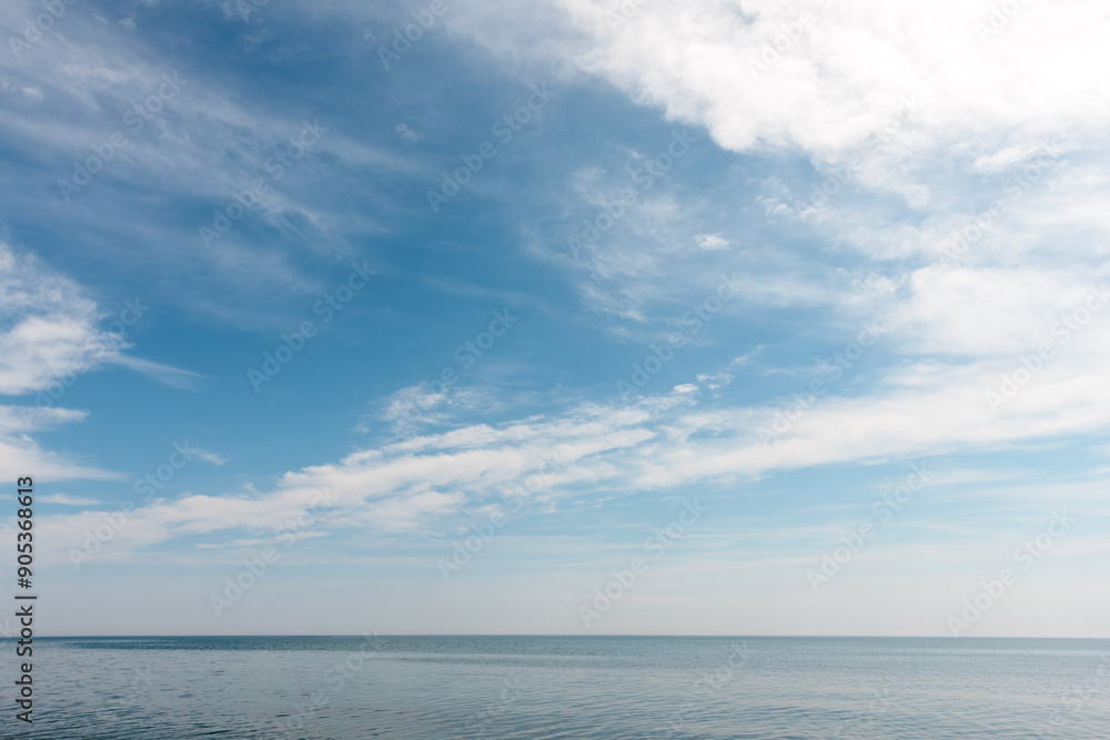 The calm waters of Lake Michigan beneath the wispy clouds, just off Point Beach State Park, Two Rivers, Wisconsin in early June