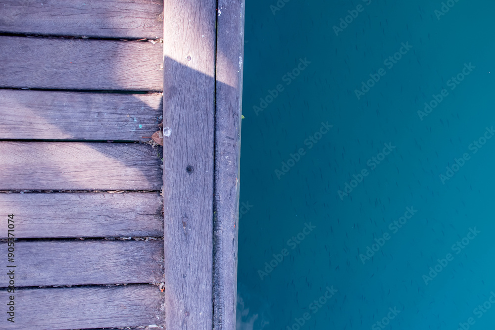Wooden deck and blue lake with fish Texture background Wooden deck and blue lake with fish Texture background