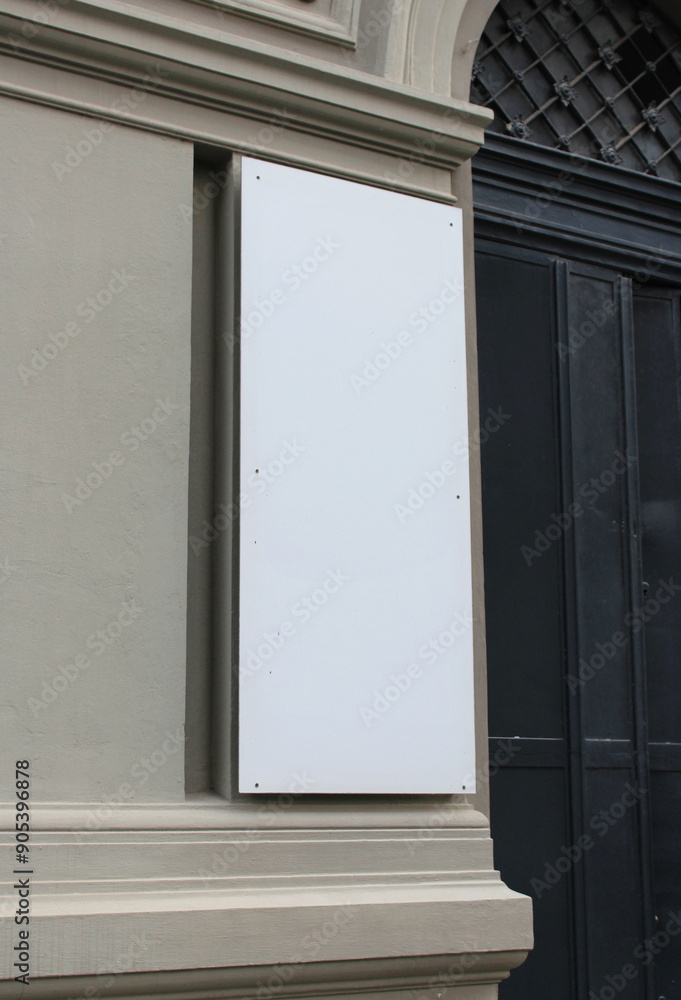 Fototapeta premium Large white billboard banner on an office or storefront mockup. Blank white office or shop sign mock up template.