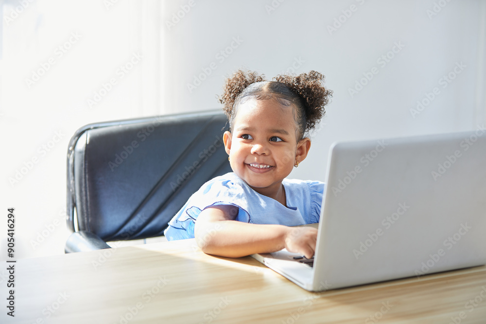 African child using a laptop computer on the table African child using a laptop computer on the table