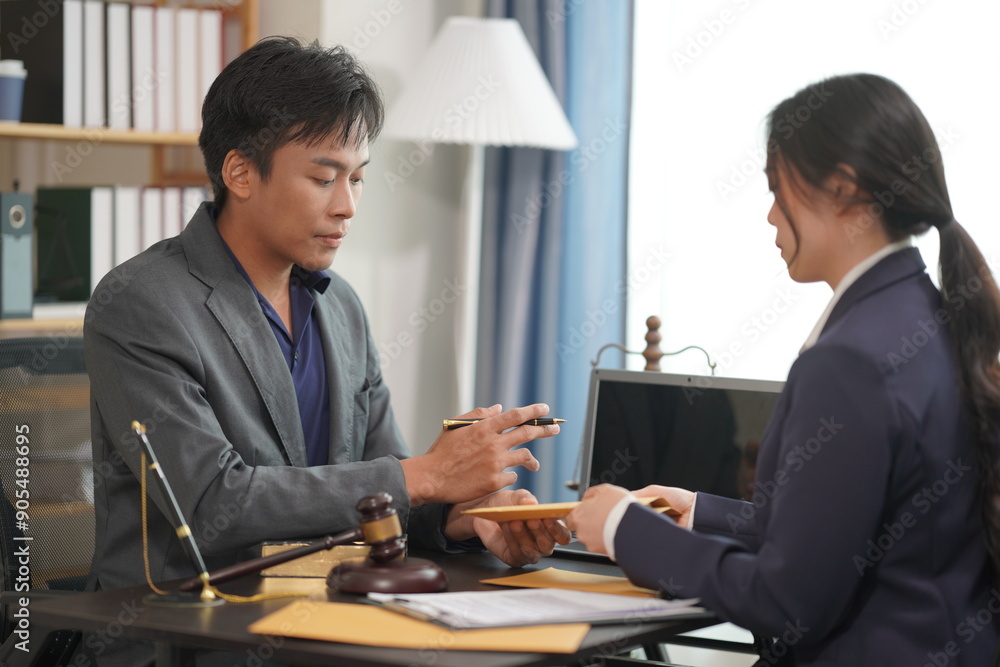 Asian business team and lawyers are discussing contract documents, sitting at the table, consulting, legal services advice, discussing and signing contracts.