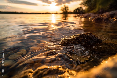 Dusk over tranquil waters with shimmering reflections and a solitary rock.