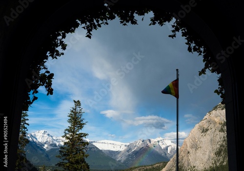 Banff National park mountain landscape with rainbow and Pride flag
