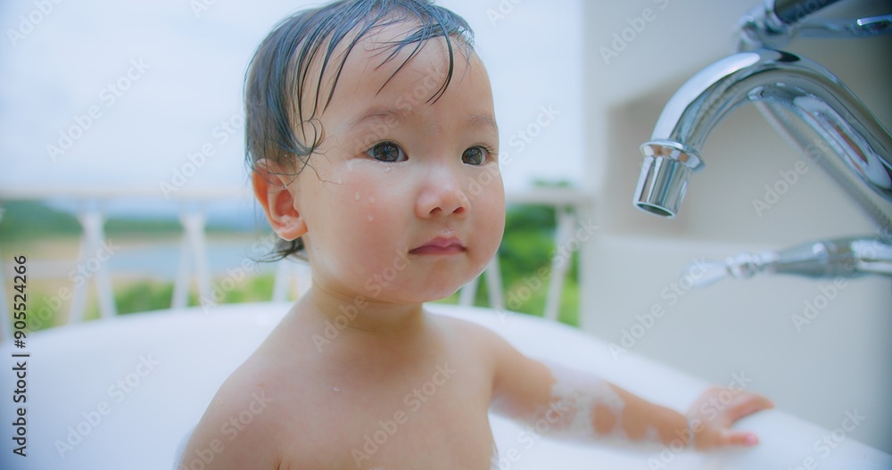 Cute toddler child having fun Enjoying during bath time outdoors with Bubbles, surrounded by nature in the Background with a serene and joyful expression. Cute toddler child having fun Enjoying during bath time outdoors with Bubbles, surrounded by nature in the Background with a serene and joyful expression.