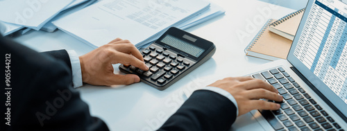Fotografie Corporate accountant use accounting software on laptop to calculate and maximize tax refunds and improve financial performance based on financial data
