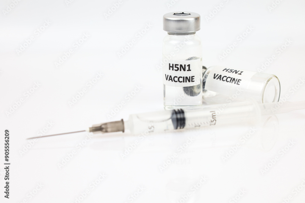Glass vials and syringe with covid H5N1 variant vaccine on white background