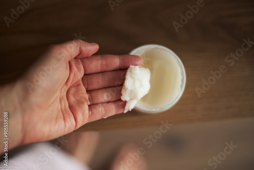 Hands taking natural moisturizing cream 