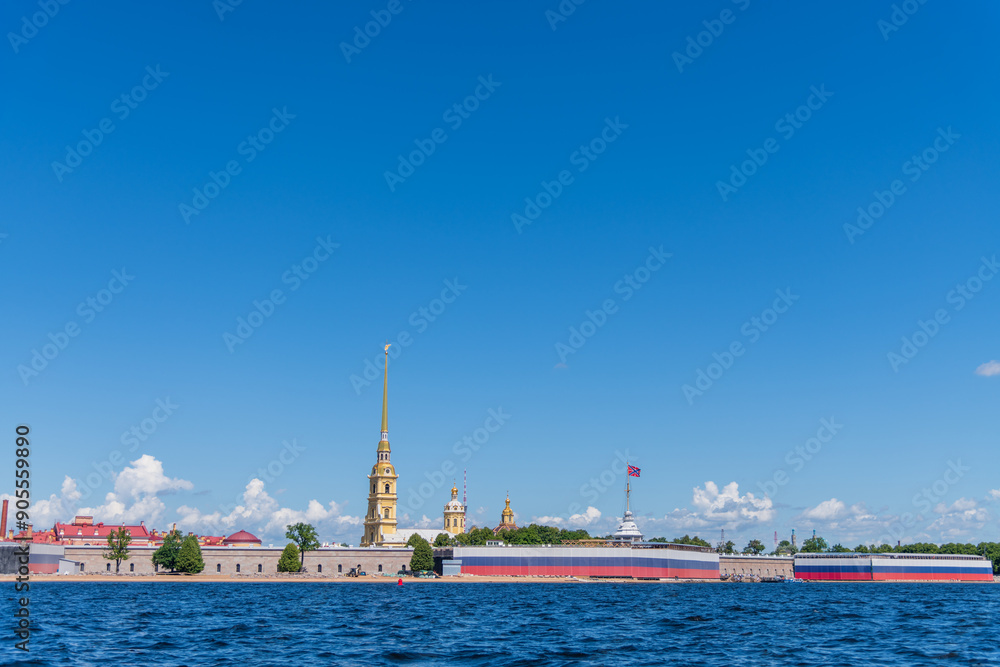 Naklejka premium Side view of Saints Peter and Paul Cathedral in Peter and Paul Fortress in a sunny summer day in Saint Petersburg, Russia. Clear blue sky. Copy space. Russian culture and architecture theme.