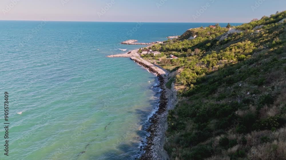 A breathtaking coastal landscape that showcases impressive cliffs, vibrant blue waters, and lush, green greenery A breathtaking coastal landscape that showcases impressive cliffs, vibrant blue waters, and lush, green greenery