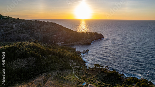 drone aerial view sunset over rocky hill in Deia in Mallorca on a hot summer day