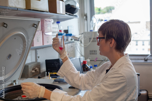 woman scientist using centrifuge in scientific laboratory photo