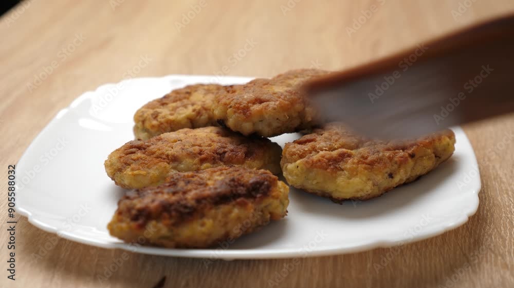 Freshly fried cutlets are placed on a plate. Freshly fried cutlets are placed on a plate.