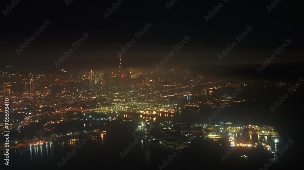 Airplane flying over Dubai Skyline illuminated at night. Airplane Jet plane taking off from Dubai airport at night Airplane flying over Dubai Skyline illuminated at night. Airplane Jet plane taking off from Dubai airport at night