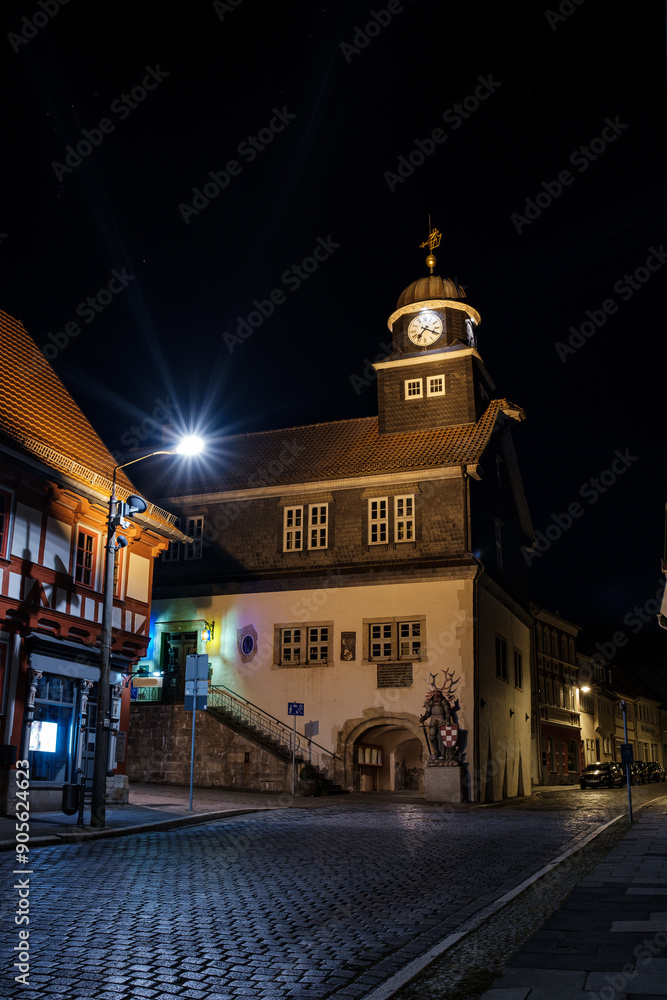 Street alley in the small town of Schwabisch Hall, with houses and buildings with typical German architecture and street lanterns, at night.