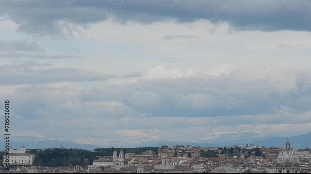 Panoramic view with city Rome in Italy, Apennine Mountains with snow, birds in flight and blue sky with white clouds on March. Topics: landscape, capital, tourism, season, geography