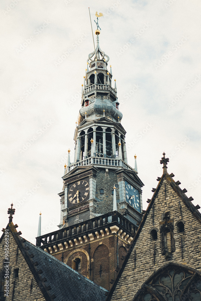 Historic clock tower in Amsterdam under overcast skies Historic clock tower in Amsterdam under overcast skies