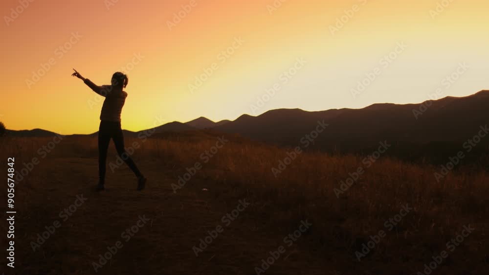 A woman stands on a mountain pathway, enjoying the breathtaking sunset views in the Carpathian Mountains, capturing a moment of joy and tranquility. A woman stands on a mountain pathway, enjoying the breathtaking sunset views in the Carpathian Mountains, capturing a moment of joy and tranquility.