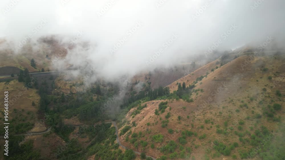 Aerial of low clouds in brown hills in White Bird Idaho along Highway 95 Aerial of low clouds in brown hills in White Bird Idaho along Highway 95