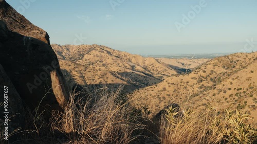 Dry grass next to rocks on mountain top near Winters california photo