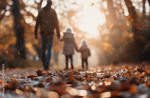 Family Walk During Autumn Sunset in a Leaf-Covered Trail