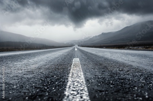 Lonely Rainy Road Under Dark Clouds in a Mountainous Landscape