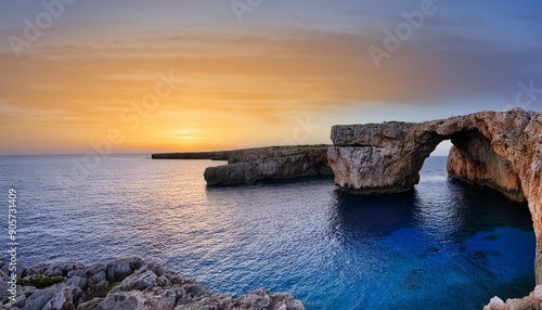 view of the landmark stone arch of pont d en gil on menorca island just after sunset photo