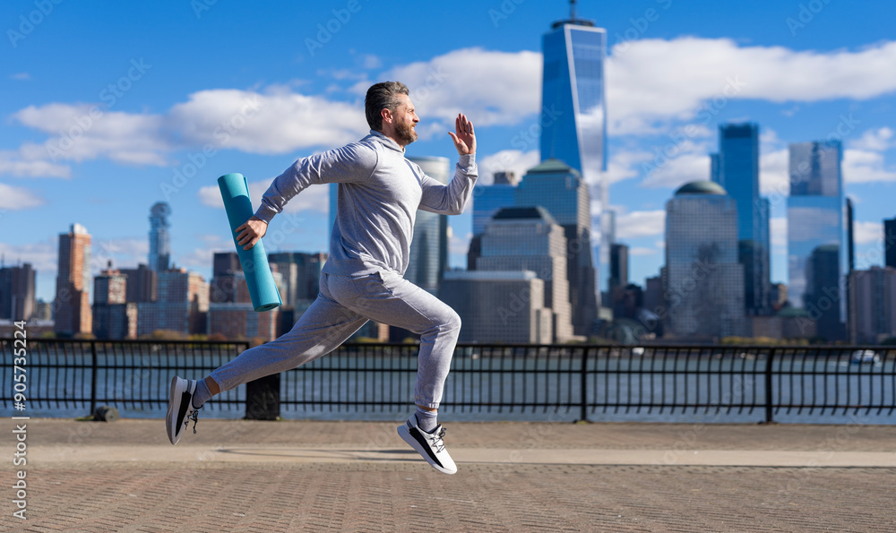 Sport runner in Manhattan. The sportsman running at view to New York. Man sportsman running for exercise in active wear. Sportsman jogger running. Copy space Sport runner in Manhattan. The sportsman running at view to New York. Man sportsman running for exercise in active wear. Sportsman jogger running. Copy space