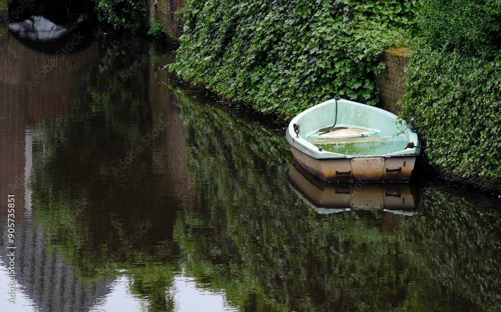 Weathered boat on the water in Amersfoort, Netherlands Weathered boat on the water in Amersfoort, Netherlands