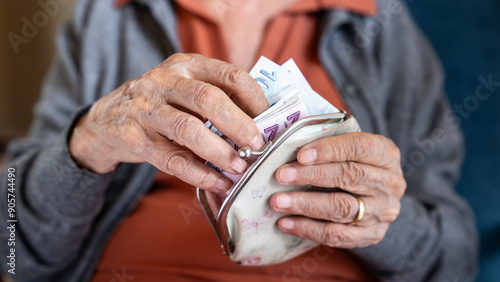 Photos Old woman counting Turkish lira banknotes