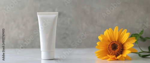 White Cream Tube Beside Bright Yellow Flowers on Grey Surface