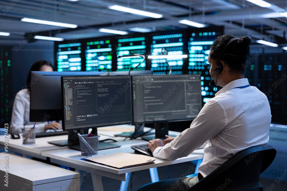 System administrator monitoring and optimizing data center performance and capacity using computer. IT specialist troubleshooting mainframes to ensure optimal performance and minimize downtime System administrator monitoring and optimizing data center performance and capacity using computer. IT specialist troubleshooting mainframes to ensure optimal performance and minimize downtime