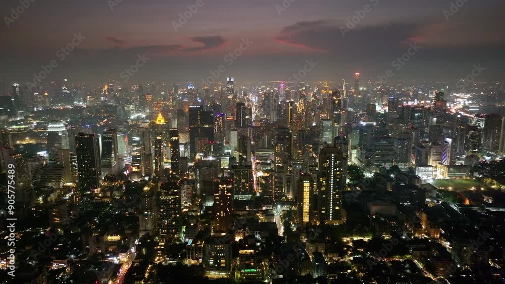 Thailand Bangkok Aerial. Night time illumination flight over Bangkok city downtown traffic street crossroad aerial topdown. Thailand Bangkok Aerial. Night time illumination flight over Bangkok city downtown traffic street crossroad aerial topdown.