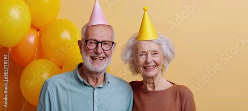Elderly Couple Celebrating a Birthday With Party Hats and Balloons in Their Home